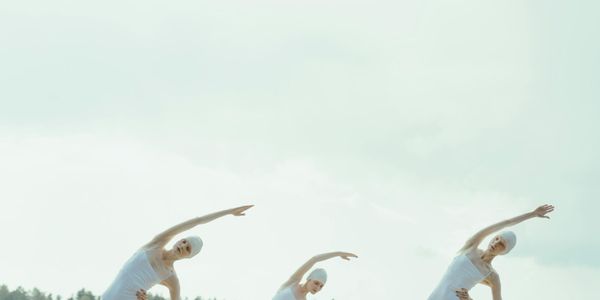 A wide shot of a person maintaining a balanced, graceful pose.